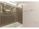 Modern glass enclosed shower with brushed nickel fixtures in a well-lit bathroom at 7086 W Spur Dr, Peoria, AZ 85383