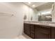 Modern bathroom with a double sink vanity, large mirror, and a glass-enclosed shower at 7086 W Spur Dr, Peoria, AZ 85383