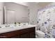 Bathroom featuring a double sink vanity with a white countertop and a shower with a decorative curtain at 7086 W Spur Dr, Peoria, AZ 85383