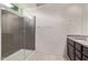Bathroom featuring a glass-enclosed shower, single sink vanity, and tile floors at 7086 W Spur Dr, Peoria, AZ 85383