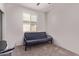 Cozy bedroom with a futon, carpet flooring, and a window bringing in natural light at 7086 W Spur Dr, Peoria, AZ 85383