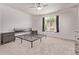 Neutral bedroom with a ceiling fan, carpeted floors, and a window overlooking the backyard at 7086 W Spur Dr, Peoria, AZ 85383
