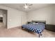 Comfortable bedroom with carpet, a queen bed, a ceiling fan, and neutral decor at 7086 W Spur Dr, Peoria, AZ 85383