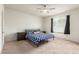 Bright bedroom featuring carpet, a ceiling fan, a queen bed, and a window with blinds at 7086 W Spur Dr, Peoria, AZ 85383