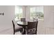 Bright dining room with a dark wood table and chairs with lots of natural light at 7086 W Spur Dr, Peoria, AZ 85383