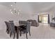 Bright dining area with modern lighting and easy access to the living room and backyard sliding door at 7086 W Spur Dr, Peoria, AZ 85383
