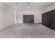 A spacious garage with gray cabinets, light concrete floors, and modern lighting at 7086 W Spur Dr, Peoria, AZ 85383