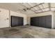 Spacious garage with custom cabinets for storage and epoxy flooring at 7086 W Spur Dr, Peoria, AZ 85383