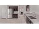 Open kitchen featuring granite countertops, stainless steel appliances, and dark wood cabinets at 7086 W Spur Dr, Peoria, AZ 85383