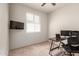 Bright office space with a desk, office chair, mounted TV, and a large window at 7086 W Spur Dr, Peoria, AZ 85383