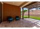 Covered patio with textured walls featuring a desert landscape and two blue chairs at 7086 W Spur Dr, Peoria, AZ 85383