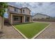 Backyard features well-maintained artificial turf and a covered patio, great for outdoor living at 8518 S 8Th Ln, Phoenix, AZ 85041