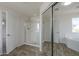 Bathroom featuring an enclosed shower, a bathtub, wood-look flooring, and dual doors at 8518 S 8Th Ln, Phoenix, AZ 85041