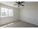 Bedroom featuring carpet flooring, ceiling fan, and natural light from the window at 8518 S 8Th Ln, Phoenix, AZ 85041