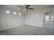 Bedroom featuring carpet flooring, ceiling fan, and natural light from the many windows at 8518 S 8Th Ln, Phoenix, AZ 85041