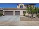 Beige two-story house with a two-car garage and tile roof at 8518 S 8Th Ln, Phoenix, AZ 85041