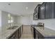 Kitchen with granite countertops, white subway tiles and dark cabinets at 8518 S 8Th Ln, Phoenix, AZ 85041