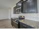 Updated kitchen with granite countertops, stainless steel appliances and dark cabinetry at 8518 S 8Th Ln, Phoenix, AZ 85041
