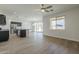 Spacious living room featuring wood floors, a ceiling fan and sliding glass doors at 8518 S 8Th Ln, Phoenix, AZ 85041