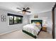 Cozy bedroom with a large window, modern ceiling fan, and comfortable bed at 8730 E Montecito Ave, Scottsdale, AZ 85251