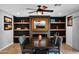 Stylish dining room with wood floors, accent wall with fireplace, and a large mirror at 8730 E Montecito Ave, Scottsdale, AZ 85251