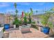 Paver patio with custom firepit, built-in seating, potted plants, and decorative wall at 8730 E Montecito Ave, Scottsdale, AZ 85251