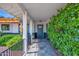 Covered front porch leads to front door with nice landscaping and new outdoor lighting at 8730 E Montecito Ave, Scottsdale, AZ 85251