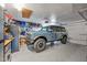 Spacious garage with a blue Bronco SUV, epoxy floors, and ample storage solutions at 8730 E Montecito Ave, Scottsdale, AZ 85251