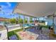 Covered patio with outdoor dining, built-in grill, and views of the pool and landscaped backyard at 8730 E Montecito Ave, Scottsdale, AZ 85251