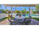 Patio with outdoor dining set overlooking the pool and spa in a lush backyard setting at 8730 E Montecito Ave, Scottsdale, AZ 85251