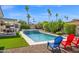 Backyard featuring a sparkling pool with a spa, mature desert landscaping, and lounge chairs at 8730 E Montecito Ave, Scottsdale, AZ 85251