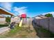 Backyard view showcasing a playset, grassy area, and covered patio with a grill at 8828 E Des Moines St, Mesa, AZ 85207
