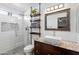 Nicely remodeled bathroom features a large walk-in shower with tile surround and granite countertop vanity at 8828 E Des Moines St, Mesa, AZ 85207