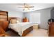 Spacious bedroom with a ceiling fan, carpet flooring, and lots of natural light at 8828 E Des Moines St, Mesa, AZ 85207
