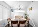 Inviting dining room featuring a modern chandelier, neutral decor, and seating for six at 8828 E Des Moines St, Mesa, AZ 85207