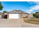 Charming single-story home with a well-maintained lawn, brick accents, and a modern garage door at 8828 E Des Moines St, Mesa, AZ 85207