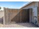 Privacy gate with a metal frame and wood slats providing access to the backyard at 8828 E Des Moines St, Mesa, AZ 85207