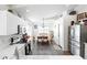 Bright kitchen and dining area features white cabinetry, stainless appliances, and stylish tile flooring at 8828 E Des Moines St, Mesa, AZ 85207