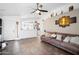 Open-concept living room with tile flooring, open access to the kitchen, and bright natural light at 8828 E Des Moines St, Mesa, AZ 85207