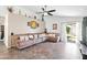 Spacious living room with tile flooring, a ceiling fan, and a sliding door leading to the backyard at 8828 E Des Moines St, Mesa, AZ 85207