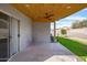 Enjoy outdoor living on this covered patio with a ceiling fan and backyard access at 8828 E Des Moines St, Mesa, AZ 85207