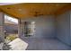 Covered patio with a ceiling fan, sliding glass doors, and concrete flooring at 8828 E Des Moines St, Mesa, AZ 85207