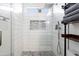 Stylish shower with a rainfall showerhead, built-in niche, and modern fixtures at 8828 E Des Moines St, Mesa, AZ 85207