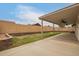 This expansive backyard features a covered patio, retaining walls and grass at 908 W Mohawk Ln, Phoenix, AZ 85027