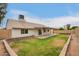 Expansive backyard with a covered patio and well-maintained lawn, ideal for outdoor relaxation and activities at 908 W Mohawk Ln, Phoenix, AZ 85027
