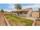 This backyard features a covered patio, retaining walls, and shed at 908 W Mohawk Ln, Phoenix, AZ 85027