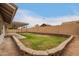 Large backyard with a covered patio, brick accents, and a well-maintained lawn, ideal for outdoor living at 908 W Mohawk Ln, Phoenix, AZ 85027