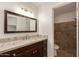 Bathroom with granite counters, wood cabinets, and walk-in shower provides a spa-like experience at 908 W Mohawk Ln, Phoenix, AZ 85027