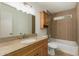 Bathroom featuring granite countertops, wood cabinets, and a shower-tub combo perfect for everyday use at 908 W Mohawk Ln, Phoenix, AZ 85027