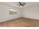 This bedroom features laminate floors, large window and ceiling fan at 908 W Mohawk Ln, Phoenix, AZ 85027